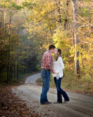 Engaged couple in fall road
