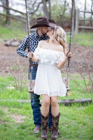 Engaged couple at swingset