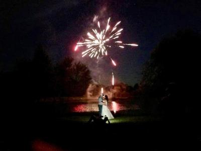 Fireworks brighten night sky over pond